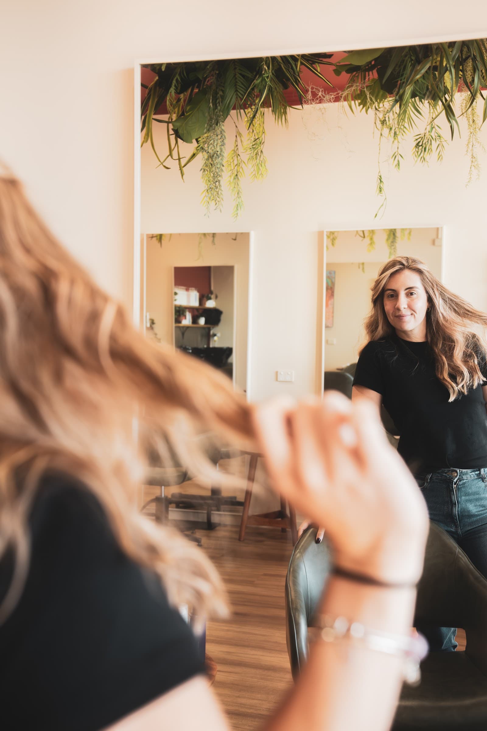 A finished haircut viewed in the mirror at Full Circle Hair Society